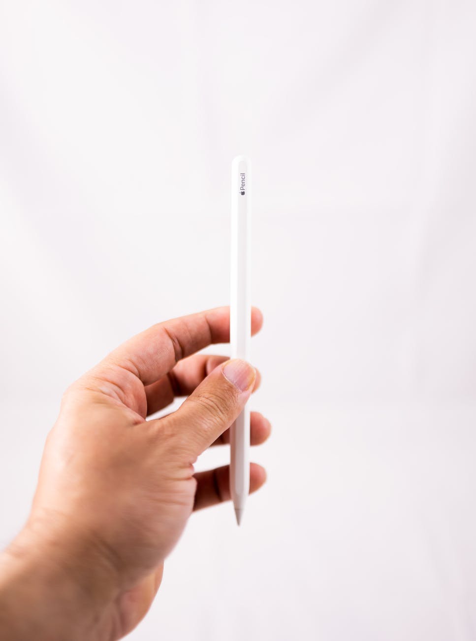 a person holding an apple pencil