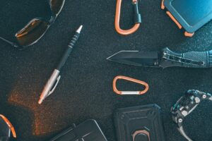 flat lay of some outdoor edc gear on a dark background